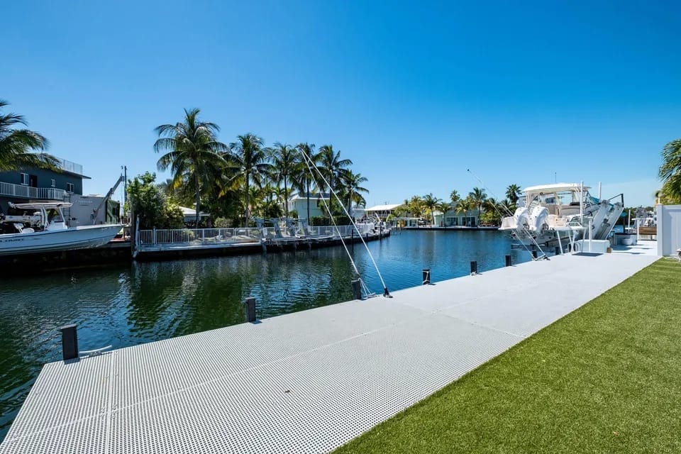 Tropical marina with moored boats and palm trees