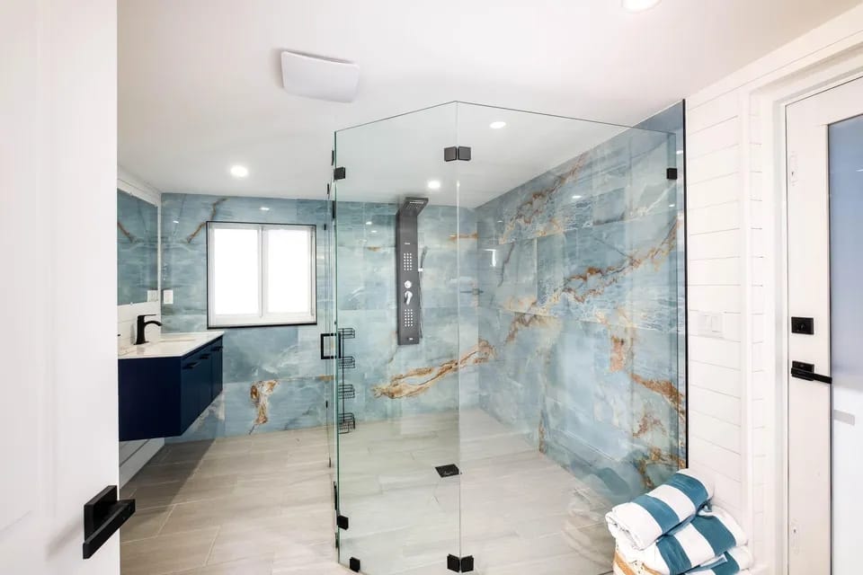Bathroom with marble shower enclosure