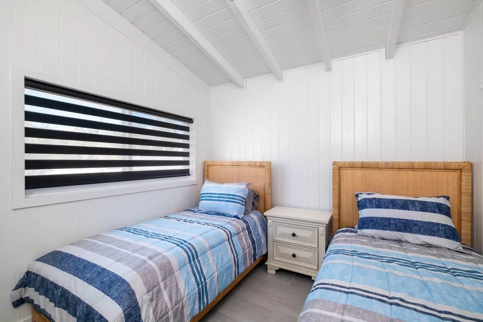 Guest bedroom with twin beds and striped bedding