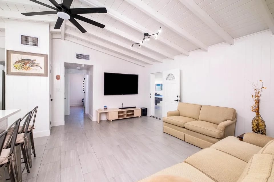 Second living area with beige sectional seating