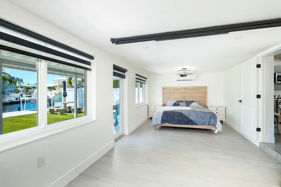 Bedroom with waterfront view and sliding glass doors