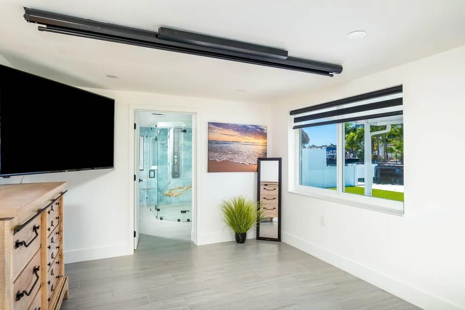 Master bedroom with waterfront view and ensuite