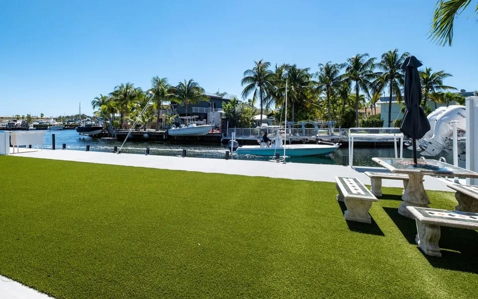 Villa Plantation waterfront property with private dock, boats, and palm trees